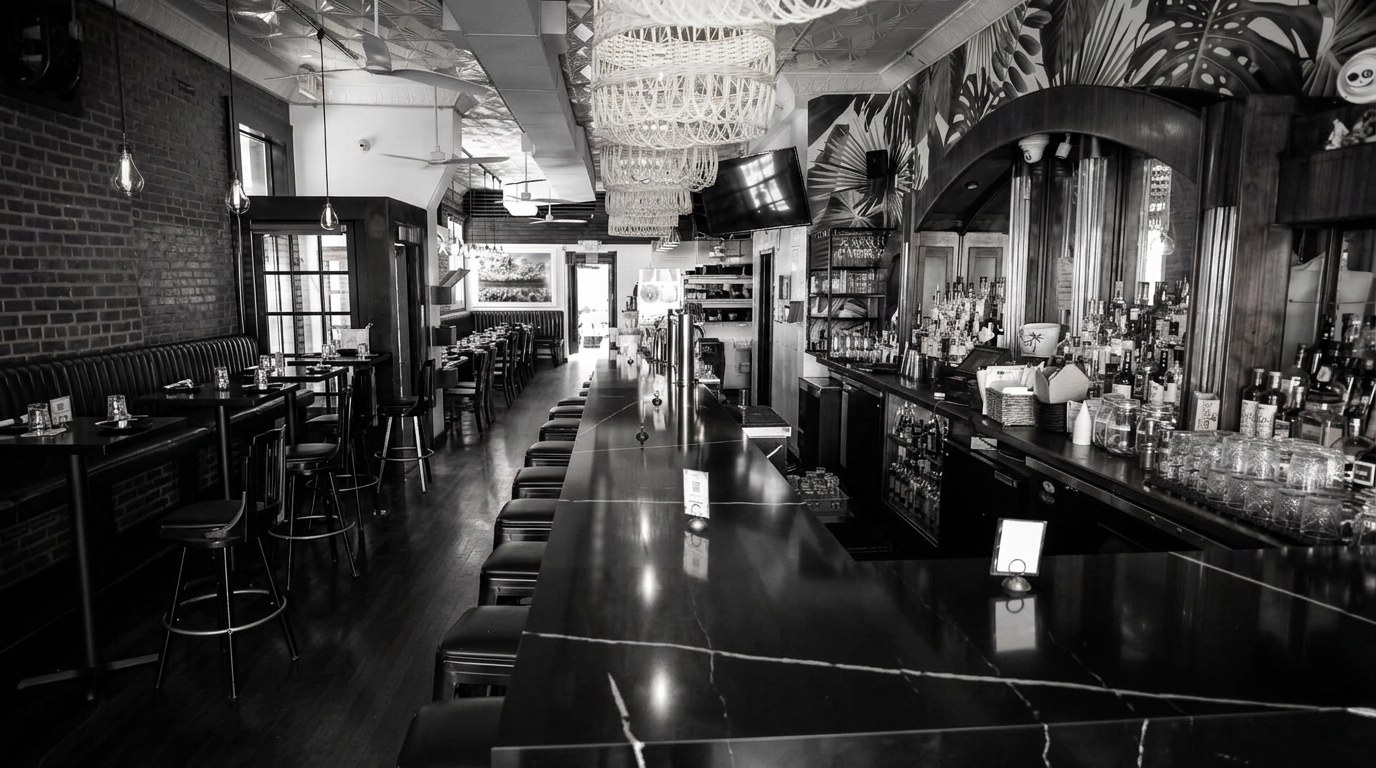 Empty black and white bar and dining room at Harry's Daughter